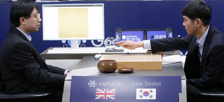 South Korean professional Go player Lee Sedol, right, puts the first stone against Google's artificial intelligence program, AlphaGo, during the final match of the Google DeepMind Challenge Match in Seoul, South Korea.