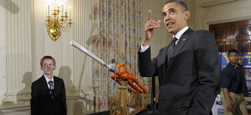 President Barack Obama watches as a marshmallow is launched by a gun designed by Joey Hudy of Phoenix, Ariz., in the State Dining Room of the White House in Washington during the White House Science Fair.