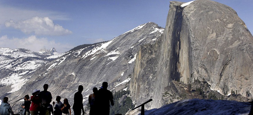 Visitors view Half Dome from Glacier Point at Yosemite National Park, Calif. 