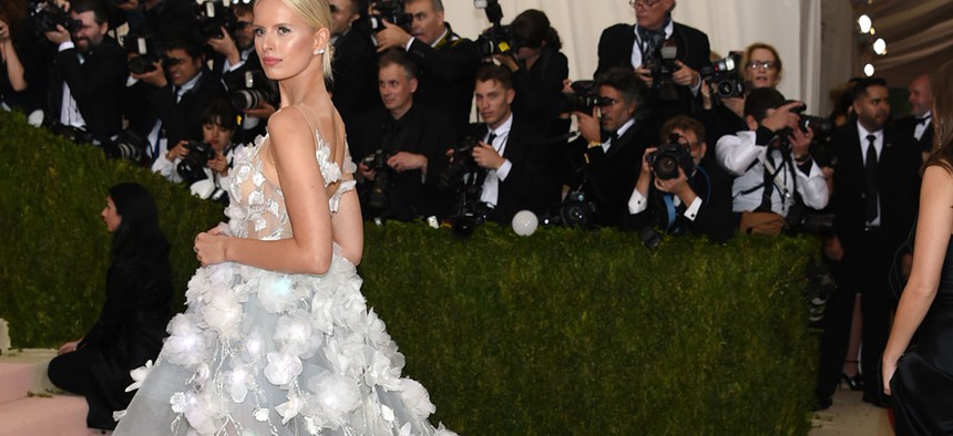 Karolina Kurkova arrives at The Metropolitan Museum of Art Costume Institute Benefit Gala with a 'cognitive' dress that had 150 LED lights which changed color when fed data from IBM's Watson.