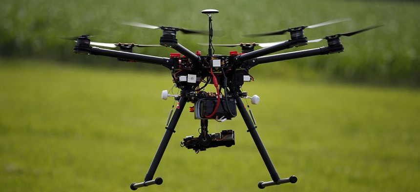 A hexacopter drone is flown during a drone demonstration at a farm and winery on potential use for board members of the National Corn Growers.