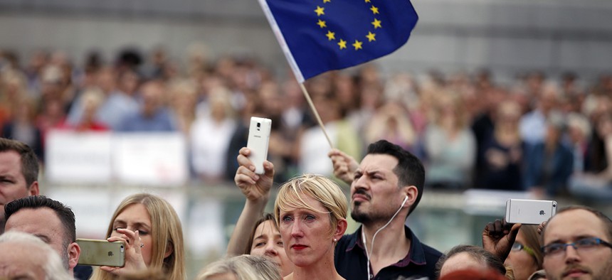 Someone waves an EU, ... ]