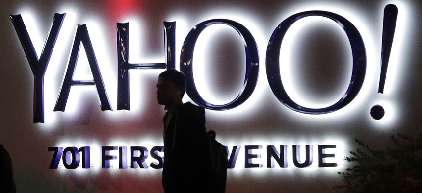 A person walks in front of a Yahoo sign at the company's headquarters in Sunnyvale, Calif. 