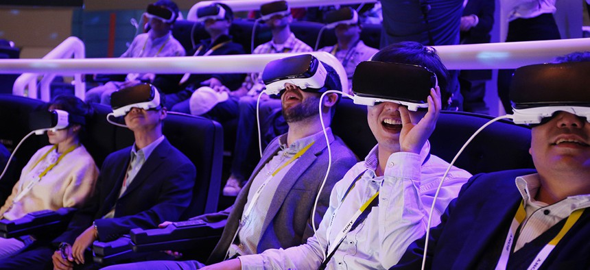 People react as they wear Samsung Gear VR goggles at CES International in Las Vegas.