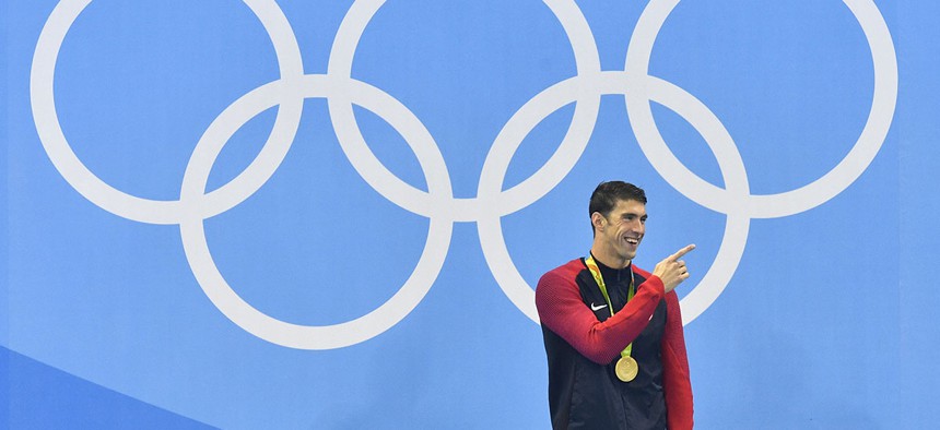 United States' Michael Phelps laughs after he was awarded the gold medal during the medal ceremony for the men's 200-meter butterfly final during the swimming competitions at the 2016 Summer Olympics.