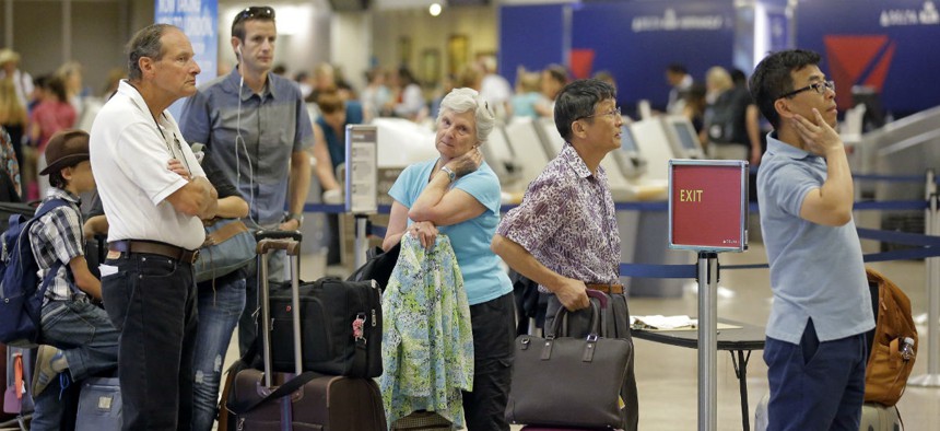 Delta passengers stand in line as the carrier slogged through day two of its recovery from a global computer outage, Tuesday, Aug. 9, 2016, in Salt Lake City. 