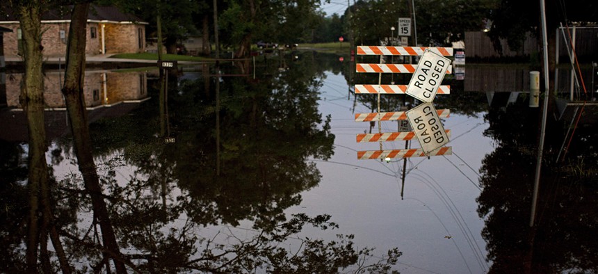 Standing water closes roads in Sorrento, La., Saturday, Aug. 20, 2016. 