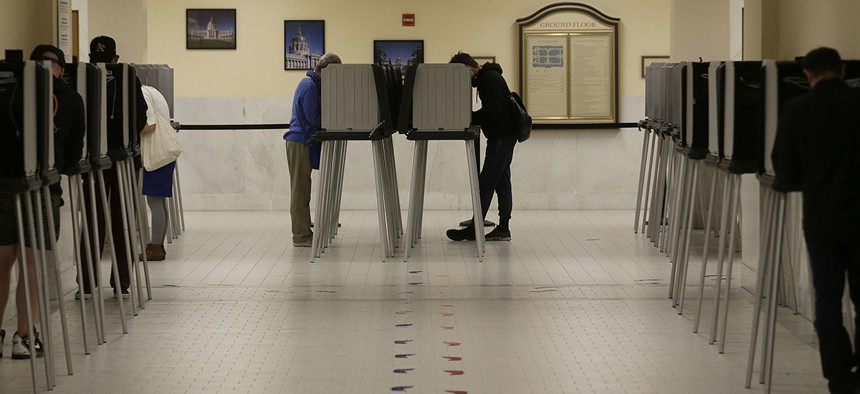 Voters cast ballots in voting booths at City Hall in San Francisco, Tuesday, June 7, 2016. 