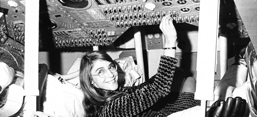 Margaret Hamilton of Cambridge, Mass., mathematic and computer programmer at the MIT Instrumentation Laboratory, sits in mock up of Apollo command module.