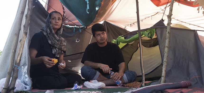 Azada Sayed, 23, left, and her husband, Hameed, 28, sit in their tent at a makeshift camp for migrants and refugees situated meters away from the Serbian border with Hungary, in Horgos, Serbia.