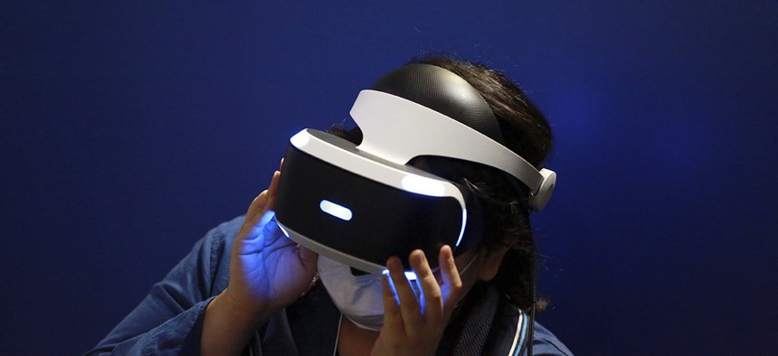 A visitor tries out a Sony's PlayStation VR headgear device at the Tokyo Game Show in Makuhari, near Tokyo.