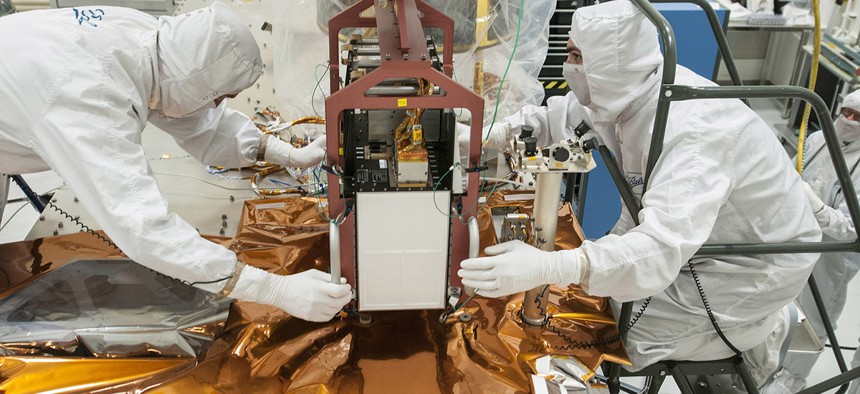 Technicians work on the JPSS spacecraft.