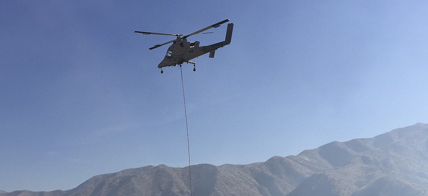 A remote-controlled Lockheed Martin K-MAX helicopter takes off Wednesday, Oct. 14, 2015, from the U.S. Forest Service’s Lucky Peak Helibase about 20 miles east of Boise, Idaho.