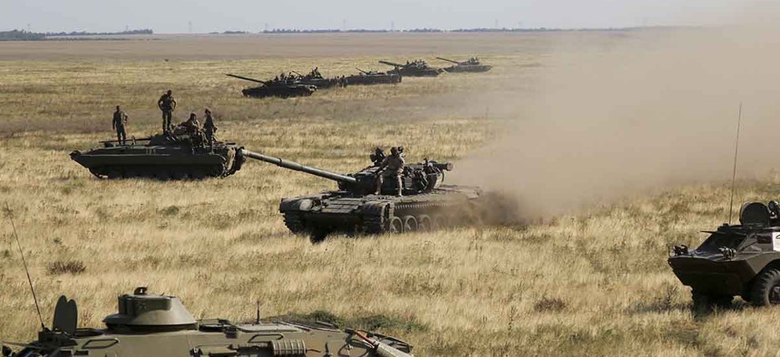 Ukrainian tanks and APCs move towards the de-facto border with Crimea near Kherson, southern Ukraine, Friday, Aug. 12, 2016.