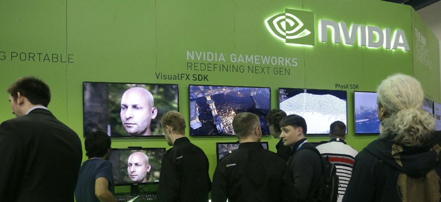 Attendees to the Game Developers Conference 2014 look at screens in the Nvidia booth in San Francisco.