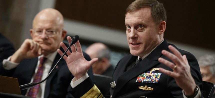 Director of National Intelligence James Clapper listens at left as National Security Agency and Cyber Command chief Adm. Michael Rogers testifies on Capitol Hill in Washington, Thursday, Jan. 5, 2017.