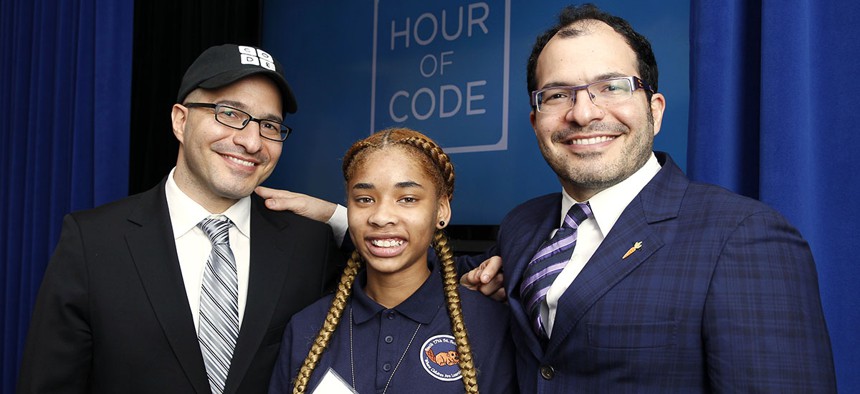 Iranian born Code.org founders Hadi Partovi, left, and Ali Partovi, right, pose with Adriana Mitchell, center, a middle school student from Newark, N.J. 