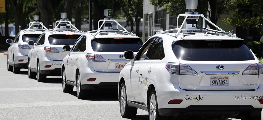 A row of Google self-driving Lexus cars at a Google event outside the Computer History Museum in Mountain View, Calif. 