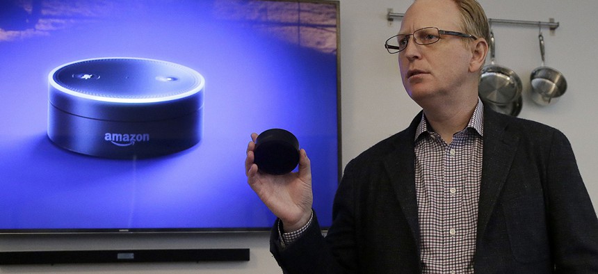 David Limp, Amazon Senior Vice President of Devices, holds an Echo Dot while speaking in San Francisco. 