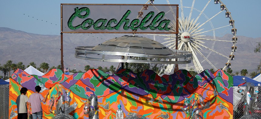 Festival-goers view the "Coachella Bound" art installation at the campgrounds at The Coachella Music and Arts Festival in 2015.