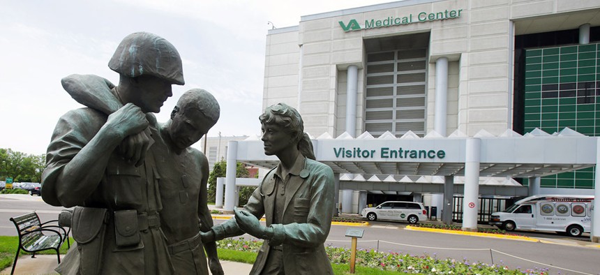 Three statues portraying a wounded soldier being helped, stand on the grounds of the Minneapolis VA Hospital, Monday, June 9, 2014.