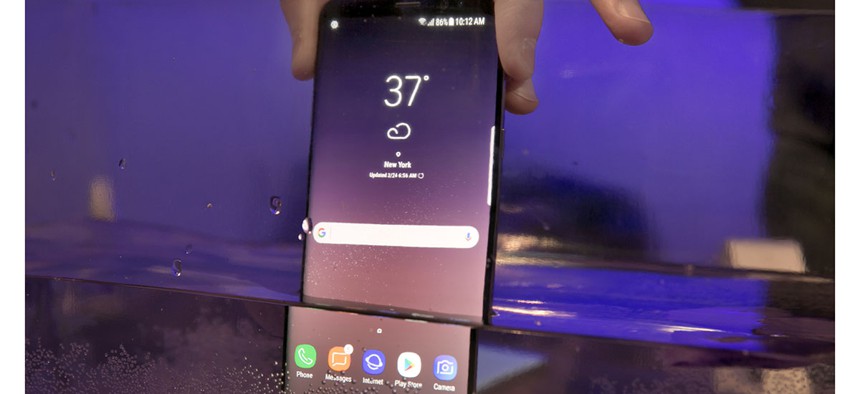 A Samsung Galaxy S8 mobile phone is shown partially submerged to demonstrate its water resistance, in New York, Friday, March 24, 2017.