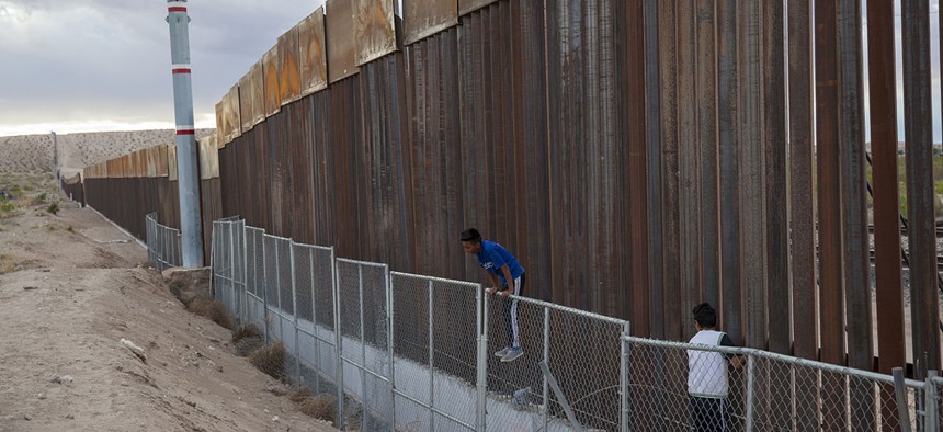 Children play on two fences marking the U.S.-Mexico border, in the Anapra neighborhood of Ciudad Juarez, Mexico, Wednesday, March 29, 2017.