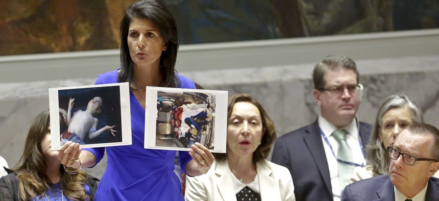 Nikki Haley, United States' Ambassador United Nations, shows pictures of Syrian victims of chemical attacks as she addresses a meeting of the Security Council on Syria at U.N. headquarters.