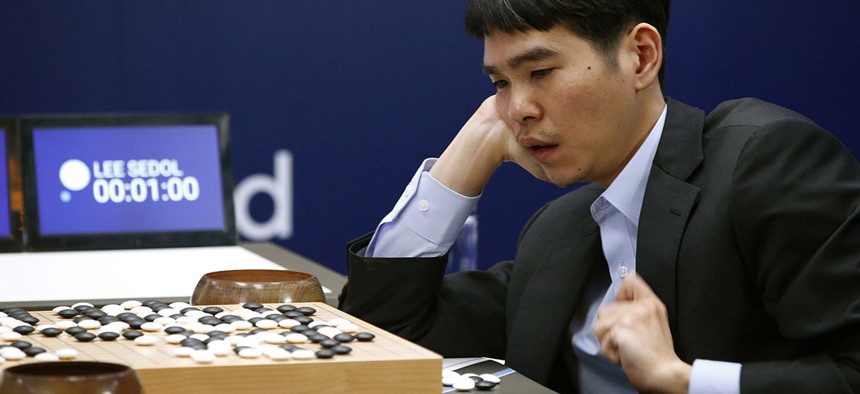 South Korean professional Go player Lee Sedol reviews the match after winning the fourth match of the Google DeepMind Challenge.