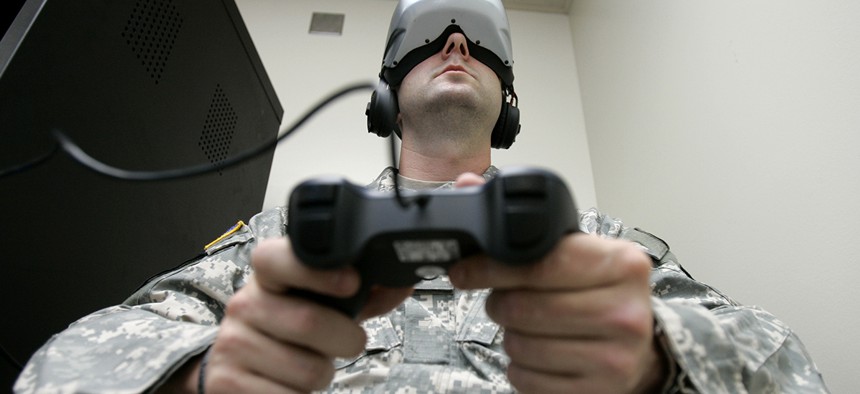 U.S. Army Staff Sgt. Jeff Ebert wears a virtual-reality headset and holds a video-game controller as he demonstrates an experimental virtual-reality computer simulation. 