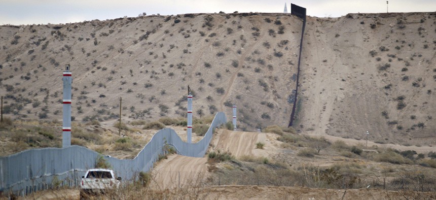 A U.S. Border Patrol agent drives near the U.S.-Mexico border fence in Sunland Park, New Mexico.