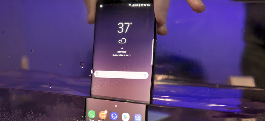 A Samsung Galaxy S8 mobile phone is shown partially submerged to demonstrate its water resistance, in New York, March 24, 2017.