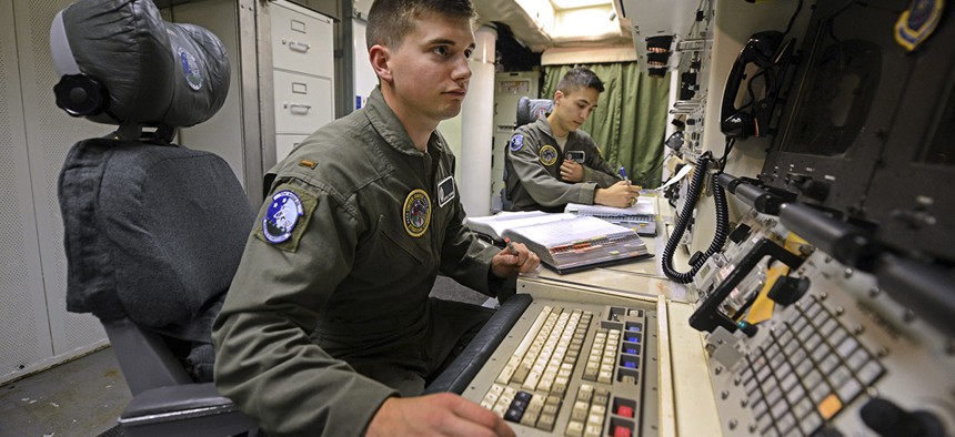 2nd Lt. Oliver Parsons, left, and 1st Lt. Andy Parthum check systems in the underground control room where they work a 24-hour shift at an ICBM launch control facility near Minot, N.D. 