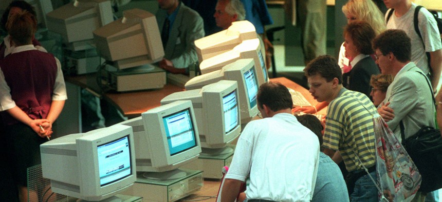 Visitors crowd the computers at the international Electronic Fair in Berlin in August 1995.