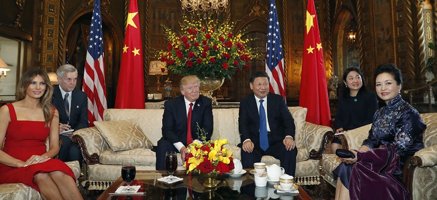 President Donald Trump and Chinese President Xi Jinping, sit with their wives, first lady Melania Trump, left, and Chinese first lady Peng Liyuan, right, before a meeting at Mar-a-Lago, April 6, 2017.