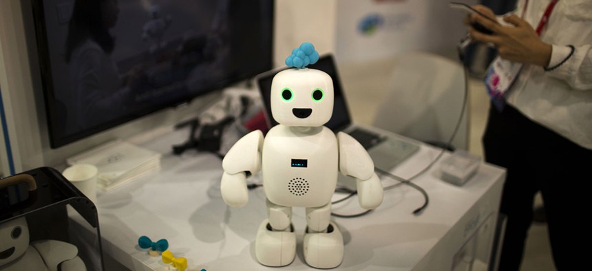 Pibo robot, whose main purpose is getting you and your loved ones sharing your daily life again, receives instructions from her owner at the Mobile World Congress.