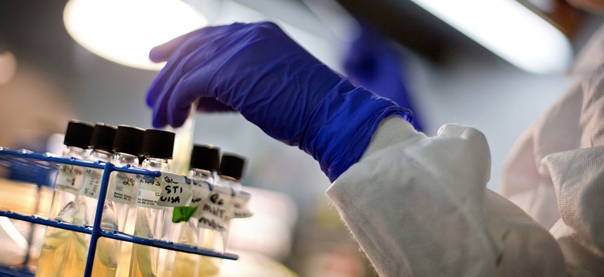 A microbiologist works with tubes of bacteria samples in an antimicrobial resistance  and characterization lab within the Infectious Disease Laboratory at the Centers for Disease Control in Atlanta.