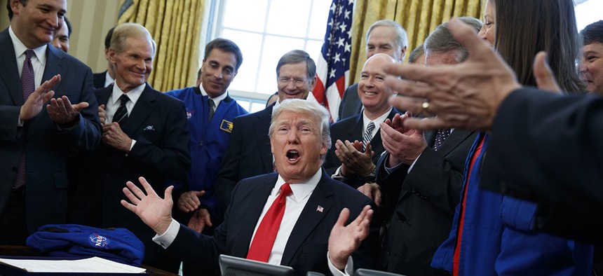 President Donald Trump speaks in the Oval Office of the White House in Washington, Tuesday, March 21, 2017, after signing a bill to increase NASA's budget to $19.5 billion and directs the agency to focus human exploration of deep space and Mars. 