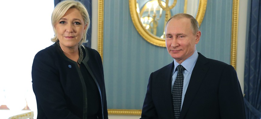 Russian President Vladimir Putin, right, shakes hands with French far-right presidential candidate Marine Le Pen, in the Kremlin in Moscow.