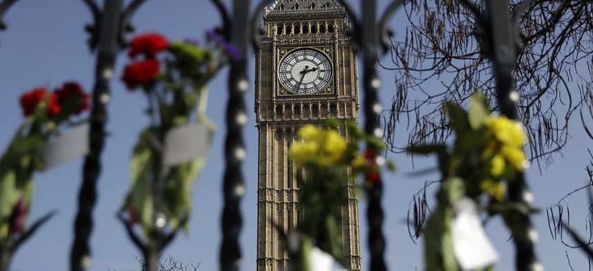 Floral tributes to the victims of the Westminster terrorist attack are placed outside the Palace of Westminster, London, Monday March 27, 2017.