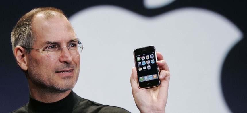 Apple CEO Steve Jobs holds up an Apple iPhone at the MacWorld Conference in San Francisco in 2007. 