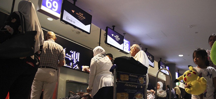 Passengers check into a flight at Abu Dhabi International Airport in Abu Dhabi, United Arab Emirates, Tuesday, July 4, 2017.