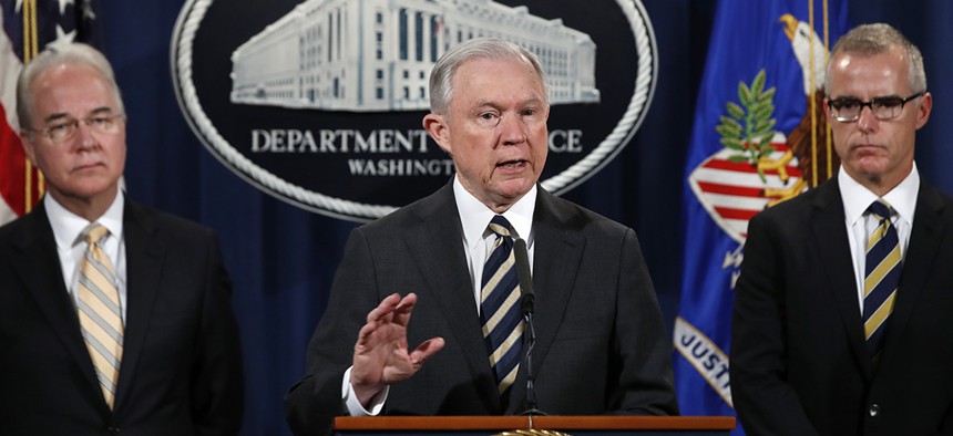 Attorney General Jeff Sessions, center, is flanked by Health and Human Services Secretary Tom Price, left, and Acting FBI Director Andrew McCabe.