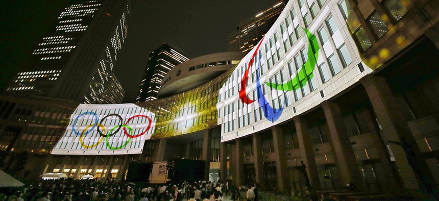 Olympic logos are projected on Tokyo Metropolitan Government building during the Tokyo 2020 flag tour festival for the 2020 Games in Tokyo, Monday, July 24, 2017. 
