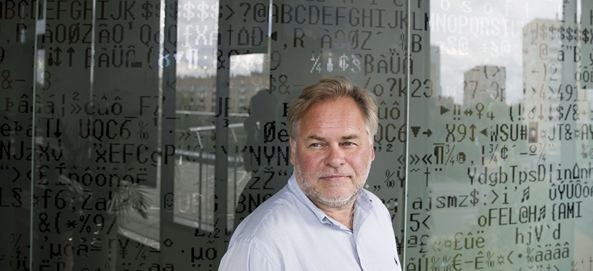 Eugene Kaspersky, Russian antivirus programs developer and chief executive of Russia's Kaspersky Lab, stands in front of a window decorated with programming code's symbols at his company's headquarters in Moscow, Russia, Saturday, July 1, 2017. 