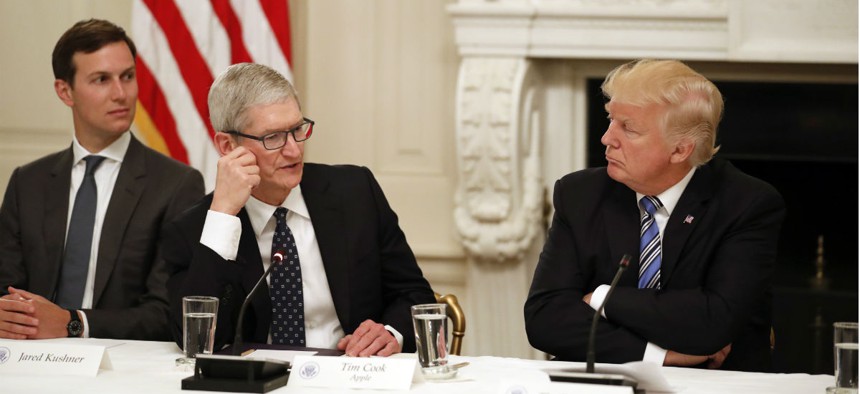Apple CEO Tim Cook with President Donald Trump, right, and Jared Kushner, White House Senior Adviser, left, at an American Technology Council roundtable on June 19.
