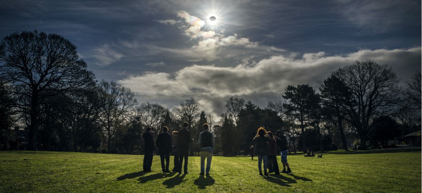 People watch a partial eclipse in Belfast, Northern Ireland, on March 20, 2015.