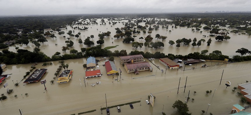 In this aerial photo, businesses and neighborhoods near Addicks Reservoir are flooded by rain from Tropical Storm Harvey Tuesday, Aug. 29, 2017, in Houston.