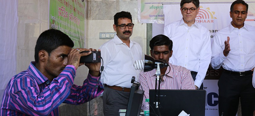 Former Treasury Secretary Jack Lew, standing second right, visits an enrollment camp for Aadhaar, India’s on going unique identification project at Koli Fishing Village in Mumbai, India