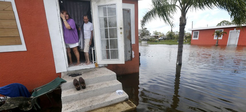 Florida residents look out at the flooding outside their home in the aftermath of Hurricane Irma in Immokalee, Fla., Monday, Sept. 11, 2017. 